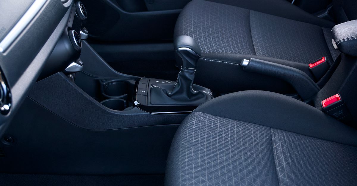 Close-up view of a sleek and modern car interior featuring a gear lever and stylish seats.